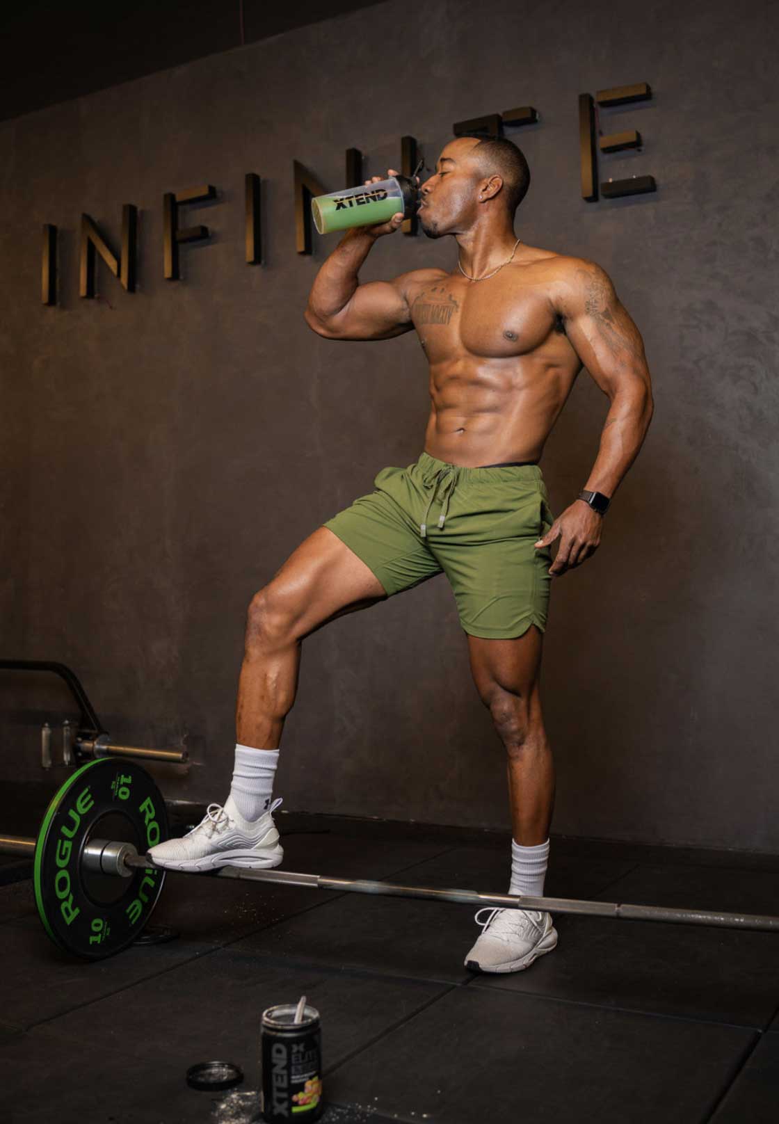 coach topless and drinking water in the gym